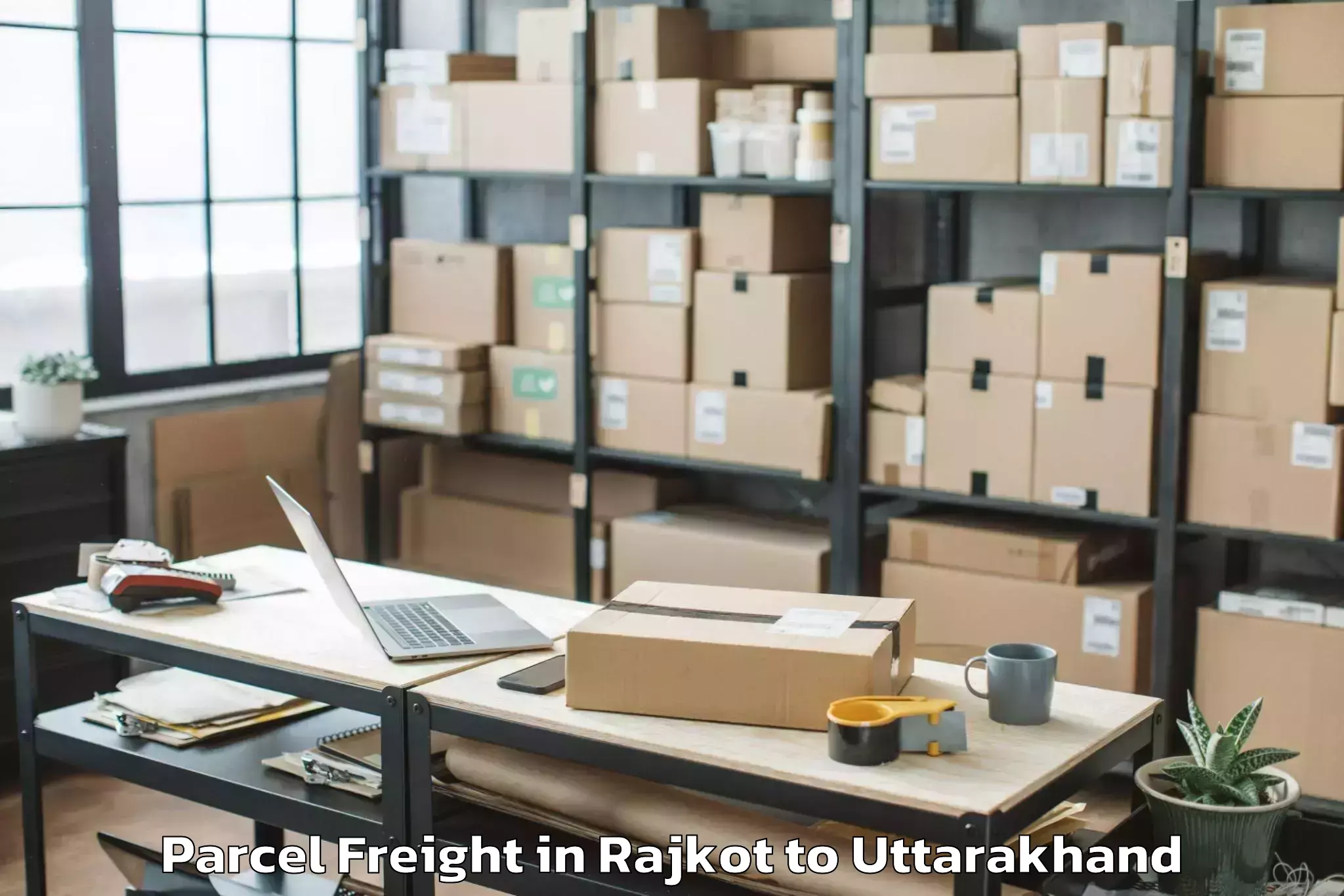 Book Rajkot to Hemwati Nandan Bahuguna Uttara Parcel Freight Online